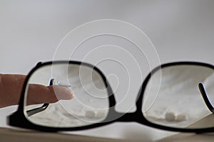 Blue contact lens through black eyeglasses shows different eyewear to correct farsightedness and nearsightedness by optometry