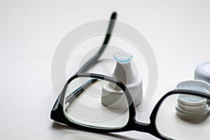 Blue contact lens through black eyeglasses shows different eyewear to correct farsightedness and nearsightedness by optometry