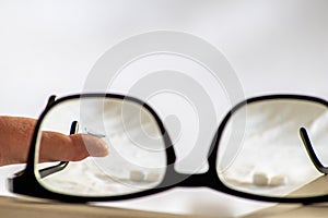 Blue contact lens through black eyeglasses shows different eyewear to correct farsightedness and nearsightedness by optometry