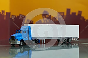 Blue Container Truck toy with Mock up container trailor side view ,selective focus ,on blur city background