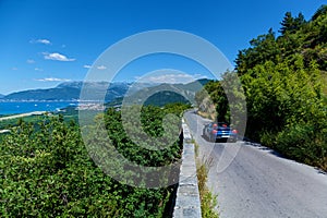 A blue convertible edits on a road photo