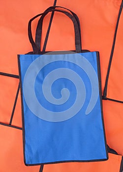 A blue cordura bag against a background of orange cordura bags photo