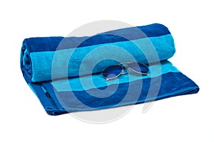 Blue cotton beach towel and sunglasses