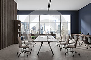 Blue coworking room interior with meeting table, panoramic window