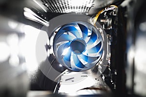 Blue cpu cooler inside PC case, shiny light background