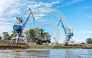 Blue cranes in cargo port, Danube river, Europe
