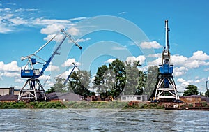 Blue cranes in cargo port, Danube river