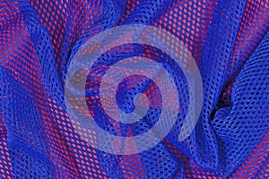 Blue crumpled nonwoven fabric on a red