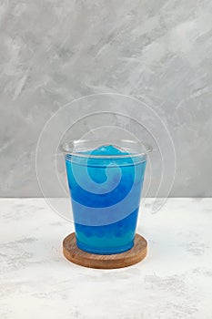 Blue Crushed ice or snow slush with tapioca pearls in disposable plastic cup. Bubble tea. Refreshing summer iced drink. Take away