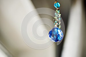 Blue crystal Feng Shui hanging on a string of beads