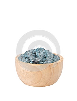 Blue crystal salt in wood bowl isolated on white background