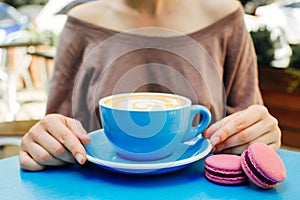 Blue cup of aromatic coffee on a blue table.