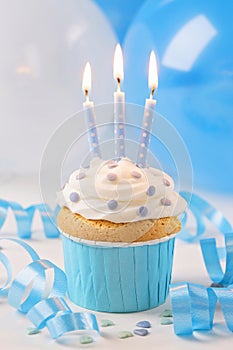 Blue cup cake with birthday candles