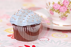 Blue cup cake with tea cup