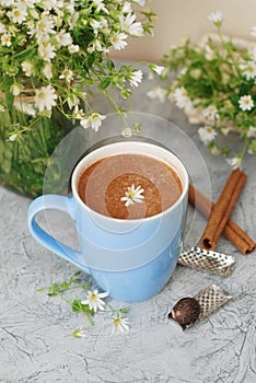 Blue Cup of Coffee Milk Latte Drink Cinnamon Sticks Wooden Background Rustic Camomile Flower Buquet Flat Lay