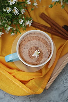 Blue Cup of Coffee Milk Latte Drink Cinnamon Sticks Wooden Background Yellow Napkin Rustic Camomile Flower Buquet Flat Lay