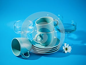 Blue cups and glasses over a blue background