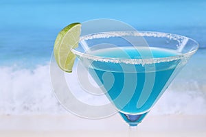 Blue Curacao cocktail on the beach with copyspace