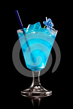 Blue Curacao cocktail garnished with a lime isolated on black background