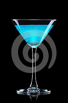 Blue Curacao cocktail in martini glass isolated on white background