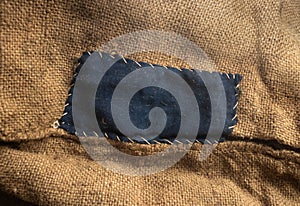 Blue-darned bag. Rough canvas, burlap, sackcloth close up