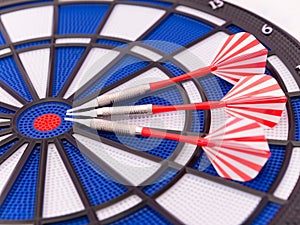 Blue dartboard with darts