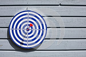 Blue dartboard and red dart.