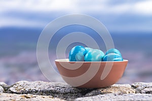 blue decorated Easter eggs painted by hand against sky background