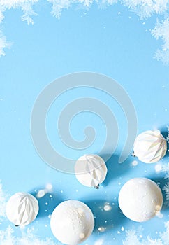 Blue delicate Christmas background with white balls. Bokeh lights. New Year`s decor. Gifts