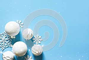 Blue delicate Christmas background with white balls. Bokeh lights. New Year`s decor. Gifts