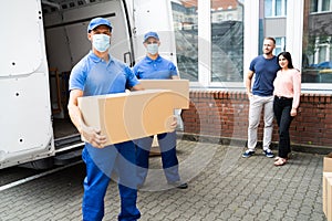 Blue Delivery Men Unloading Package From Truck