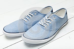 Blue denim casual sneakers on white background