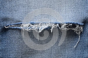 Blue denim jeans background. ripped detail. Texture, close up