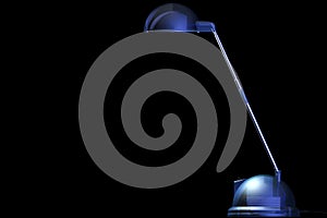 Blue desklamp on black