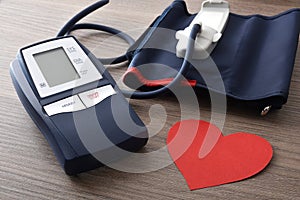Blue digital blood pressure monitor for home on wooden table