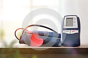 Blue digital blood pressure monitor on the table at home