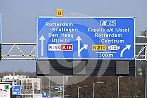 Blue direction and information sign for the directions on Motorway A16 to Capelle on N210