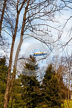 Blue dirigible flying in cloudy sky