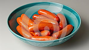 A blue dishware containing sausages, a root vegetable, and produce