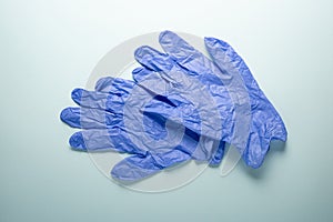 Blue disposable medical gloves on a light