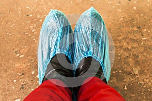 blue disposable shoe covers are worn on the upper shoes