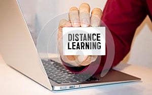 Blue distance learning button on white keyboard