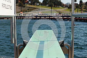 blue diving board pocking out over the waves in a bay and protected sea bath in Geelong, coastal Victoria