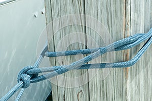 Blue docking line, tied to dock with a bowline knot