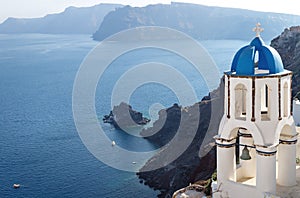 Blue dome bell tower on the cliff of Oia, Santorini, Greece
