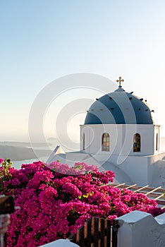 Blue dome church with a bell tower in Imerovigli village, Santorini island