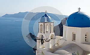 Blue dome church with belltower on the cliff of Oia, Santorini, Greece