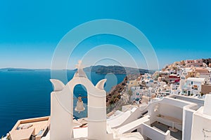 Blue dome and white Church bell tower in the village of Oia in Santorini, Greece