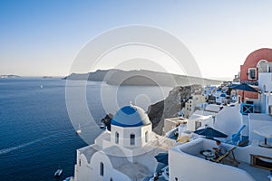 Blue dome and white Church bell tower in the village of Oia in Santorini, Greece