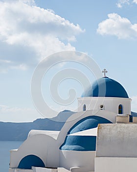 Blue dome white church in Oia village, Santorini island, Greece